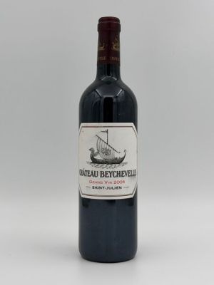 the bottle of red wine is sitting on a white surface