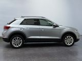 a silver volkswagen suv parked in a room with a gray wall