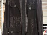 black leather jacket hanging on a rack in a store