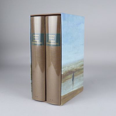 two books sitting on top of each other on a white surface