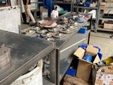 a man that is standing in a kitchen with many items on the counter