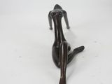 bronze figurine of a woman lying down on her back
