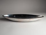 a close up of a bowl on a white surface