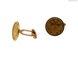 an image of a close up of a coin and a pair of cufflinks