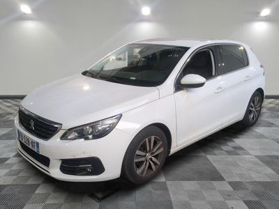 la voiture blanche est garée sur un sol en damier dans le garage