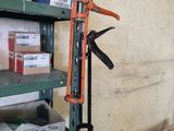 a shelf with a pair of scissors hanging on it