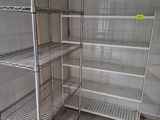 a metal shelving in the corner of a room