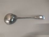 a silver spoon with a metal handle on a table