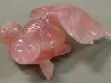 a pink fish that is sitting on a table