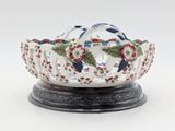 a white bowl with red and blue flowers on it