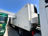 two trucks parked next to each other in a parking lot