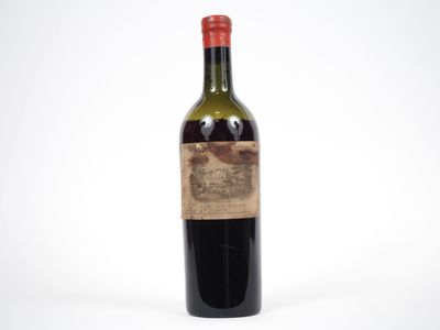une vieille bouteille de vin posée sur une surface blanche