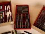 many different types of silverware in a wooden box