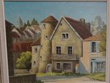 a painting of a house in a frame on the wall