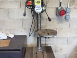 an image of a drill press in a workshop