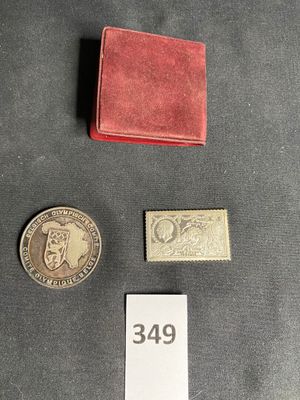 two coins and a small red wallet sitting on a table