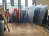 several pieces of metal are stacked up in a large warehouse