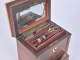 a small wooden box with a mirror and a pair of scissors in it