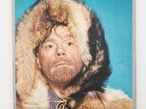 an old photo of a man in a fur coat with a hood over his head