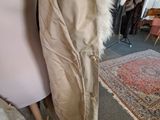 a mannequin and a coat on display in a room