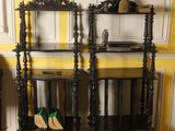 two wooden shelves on a yellow wall with a pair of shoes on top of them