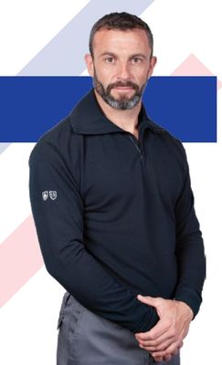 a man that is standing in front of a blue and white background