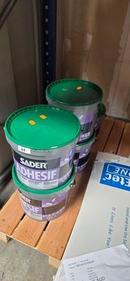 three buckets of paint sitting on a pallet