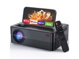 a small projector with a remote control on top of it