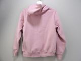 pink hoodie on a hanger on a wall in a room