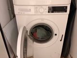 an image of a washer and dryer in a small room