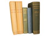 three books are lined up on top of each other on a shelf