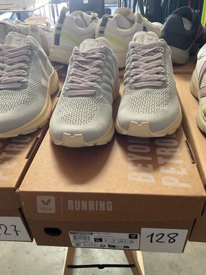 several pairs of running shoes are on display in a store
