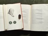 an open book with a pair of scissors on top of it