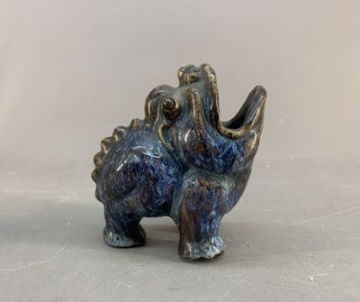 a small elephant figurine sitting on a table