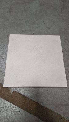a piece of paper sitting on the floor next to a pair of scissors