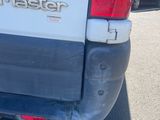 the back end of a white van parked in a parking lot