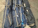 a pile of luggage sitting on the floor in a garage
