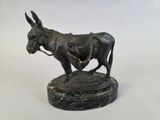 bronze statue of a donkey with a saddle on a marble base