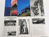 an image of a bunch of old car brochures sitting on top of a table