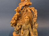 a carved figurine of a woman and child