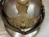 a silver helmet with a gold decoration on it