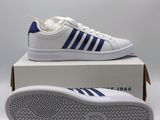 a pair of white and blue sneakers sitting on top of a box