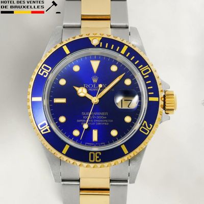 a watch with a blue face and yellow hands