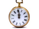 a gold pocket watch with roman numerals on the face