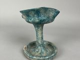 an image of a small blue vase sitting on top of a table