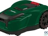 a green robotic lawn mower with a red handle