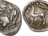 a silver coin with an image of a horse on it