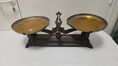 a pair of brass scales on a white table