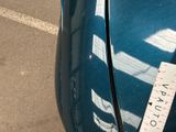 a sticker on the hood of a blue car