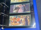 a blue binder with three pictures of people on it